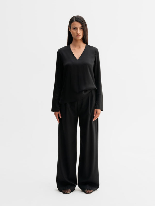Model wearing Ahlvar Gallery Kelly v-neck silk blouse in Black