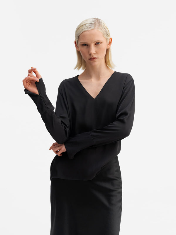 Model wearing Ahlvar Gallery Kelly v-neck silk blouse black
