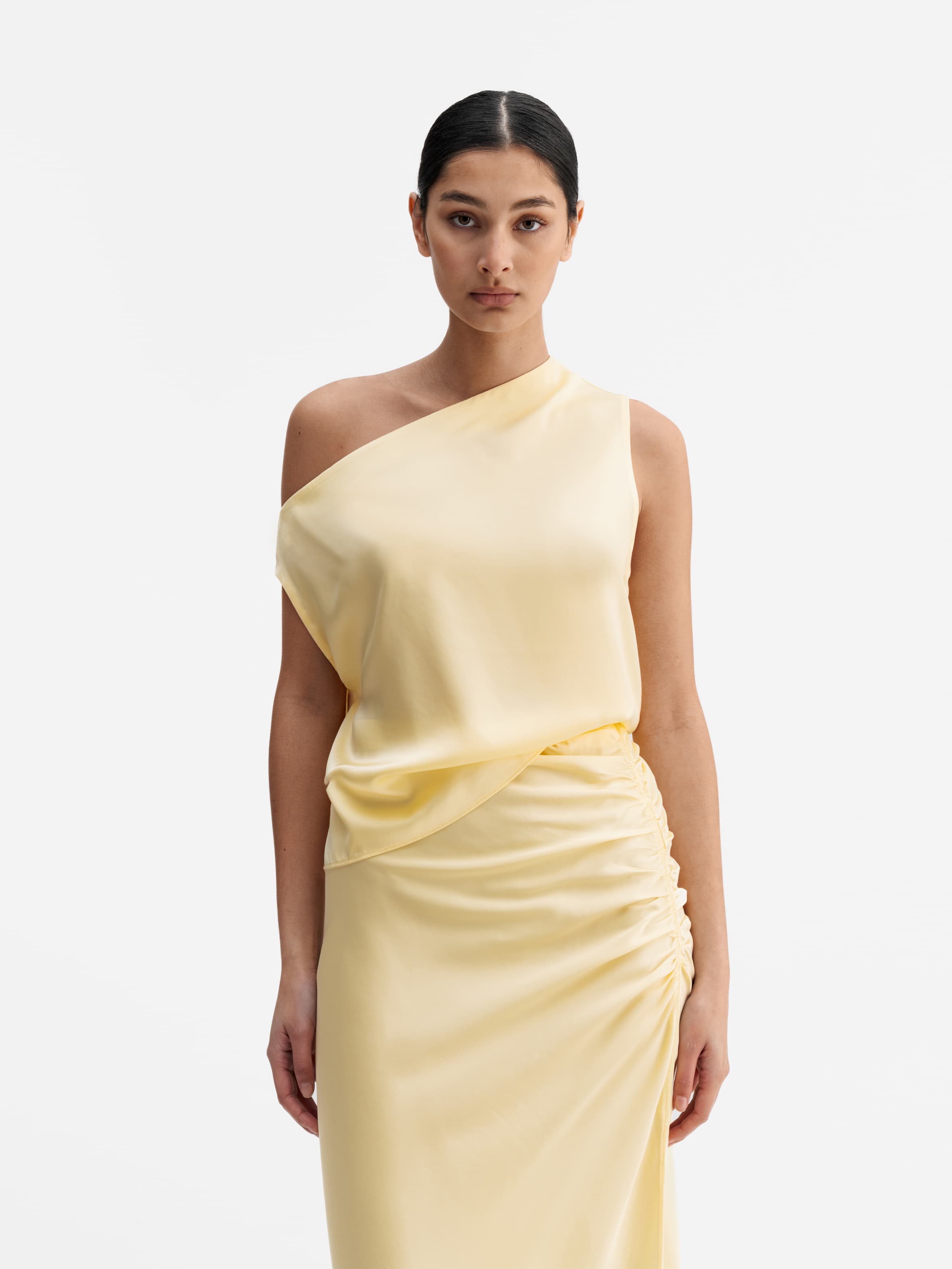 Model wearing Ahlvar Gallery Lacy satin tank light yellow