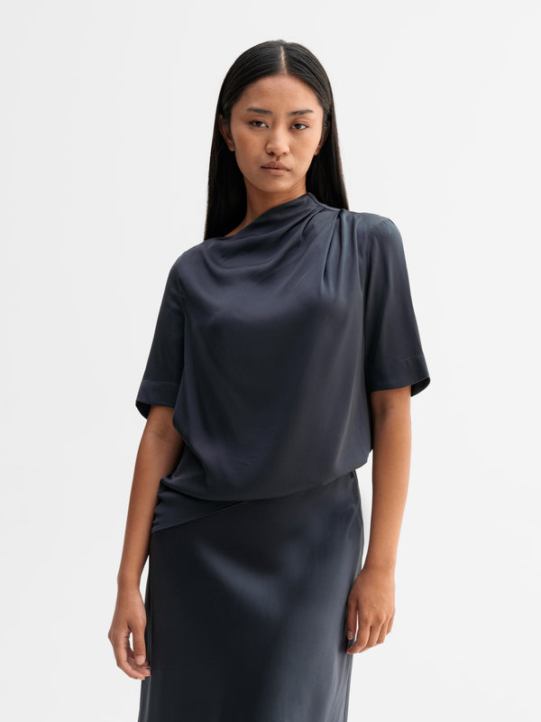 Model wearing Ahlvar Gallery Lima silk tee in Blue grey