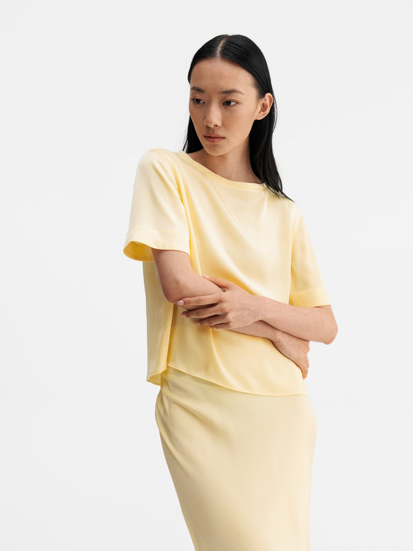 Model wearing Ahlvar Gallery Lola satin tee light yellow