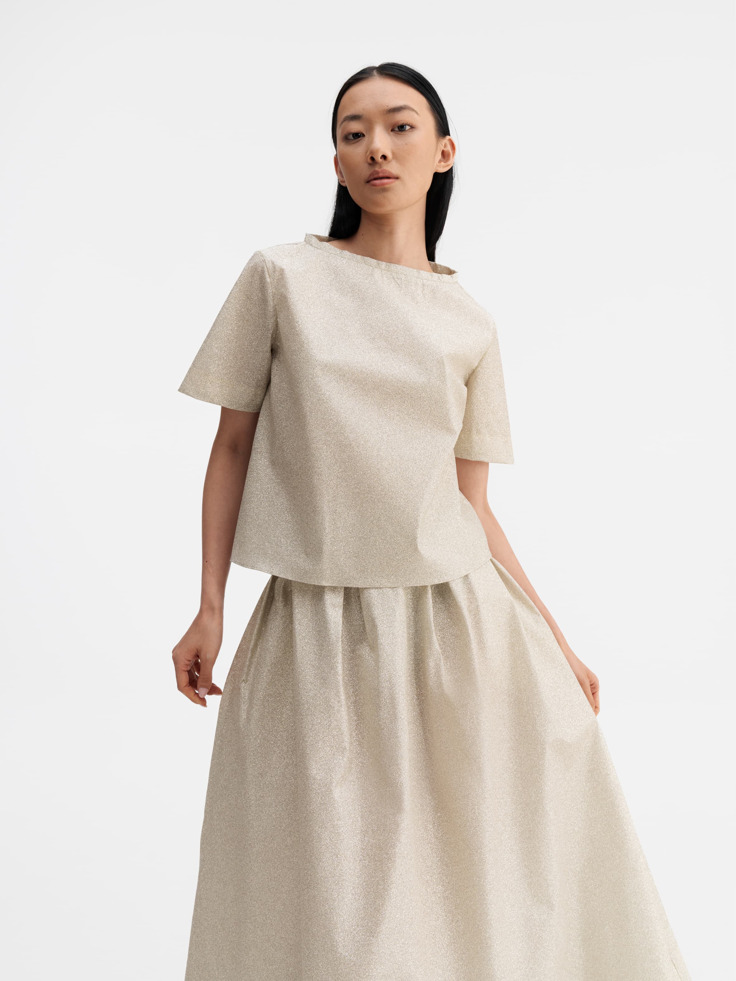 Model wearing Ahlvar Gallery Mace shimmer skirt cream