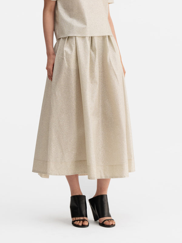 Model wearing Ahlvar Gallery Mace shimmer skirt cream