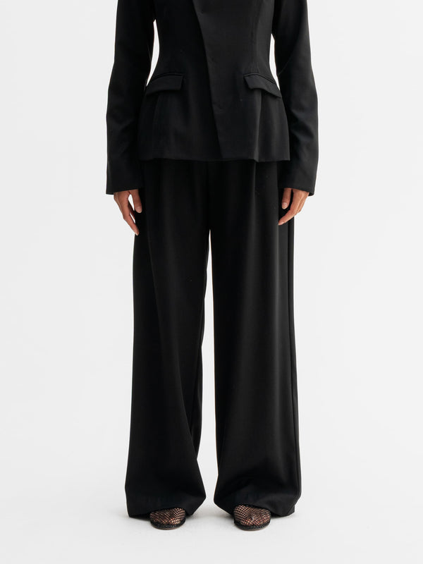 Model wearing Ahlvar Gallery Mel heavy wool trousers in Black