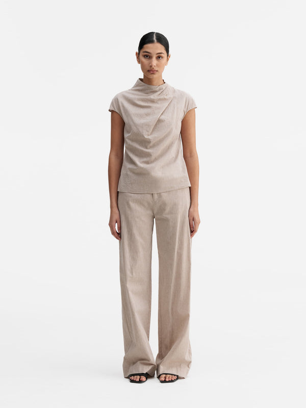 Model wearing Ahlvar Gallery Meya linen trousers cream