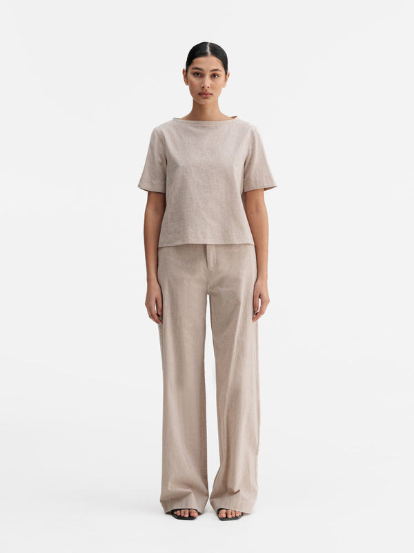 Model wearing Ahlvar Gallery Meya linen trousers cream