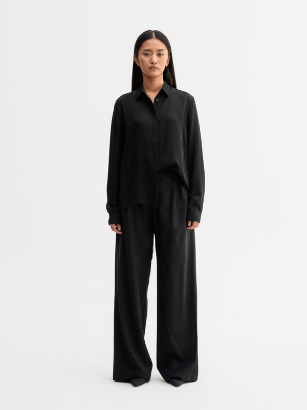 Model wearing Ahlvar Gallery Mia silk shirt in Black