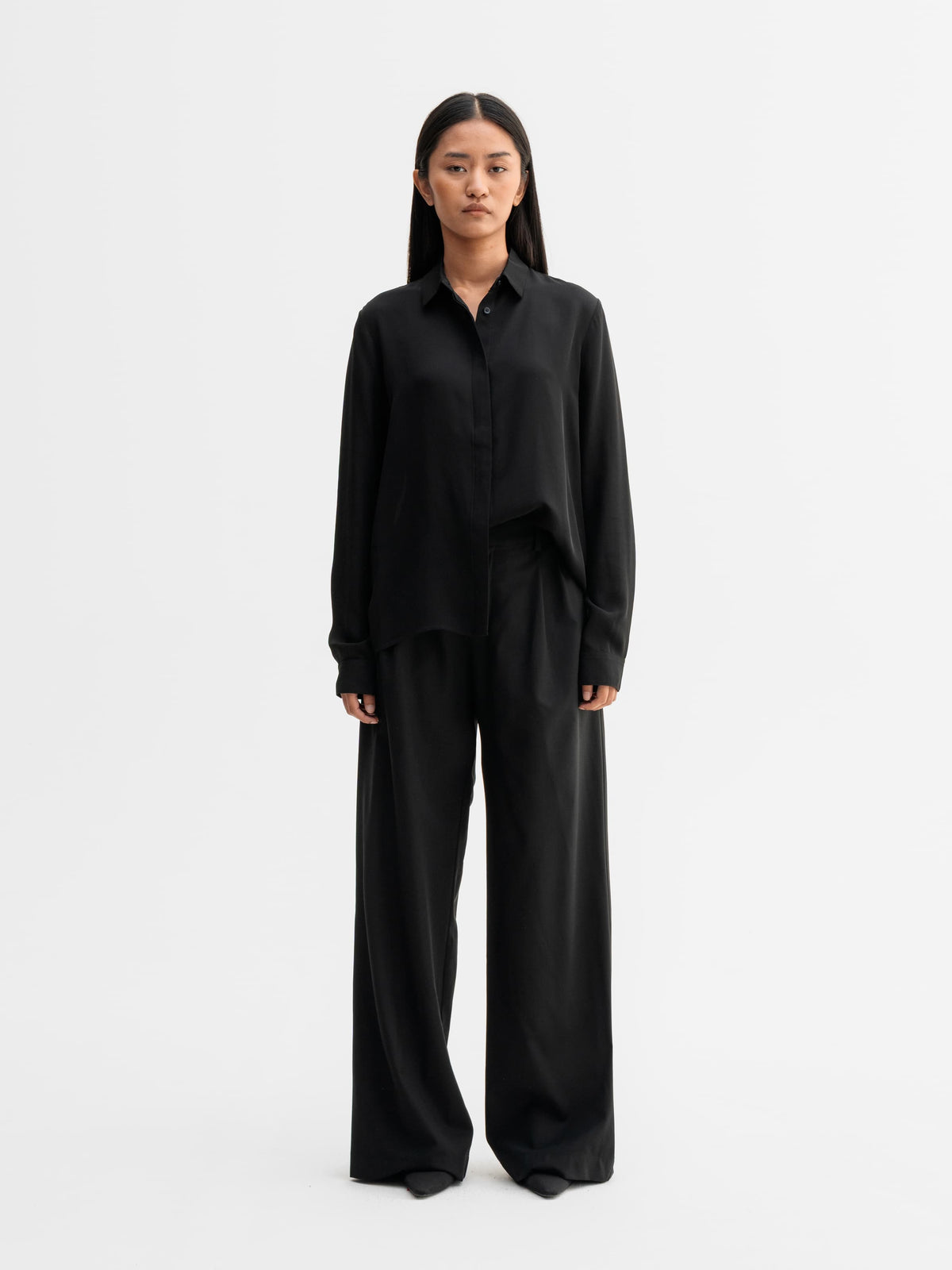 Model wearing Ahlvar Gallery Mia silk shirt in Black