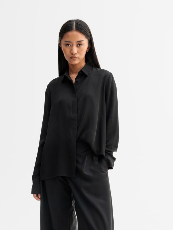 Model wearing Ahlvar Gallery Mia silk shirt in Black