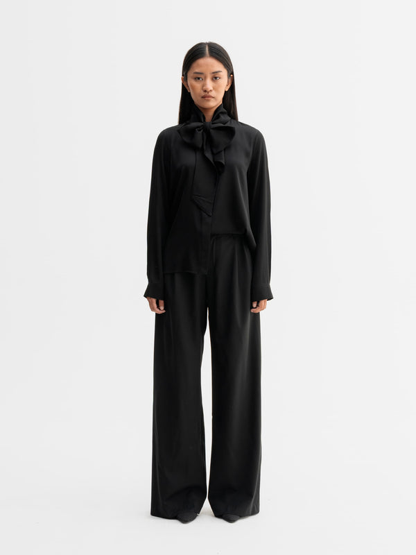 Model wearing Ahlvar Gallery Miki silk blouse in Black