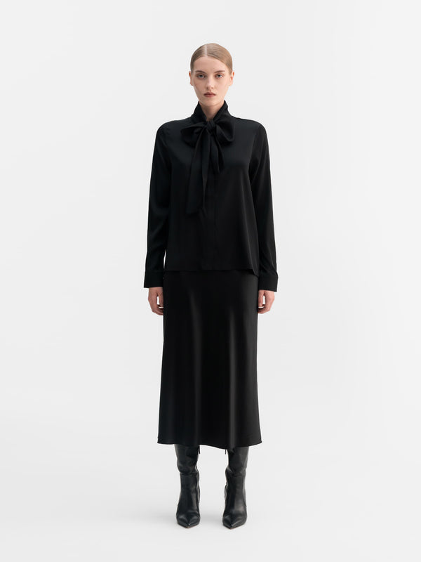 Model wearing Ahlvar Gallery Miki silk blouse in Black
