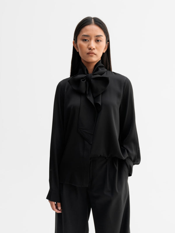 Model wearing Ahlvar Gallery Miki silk blouse in Black