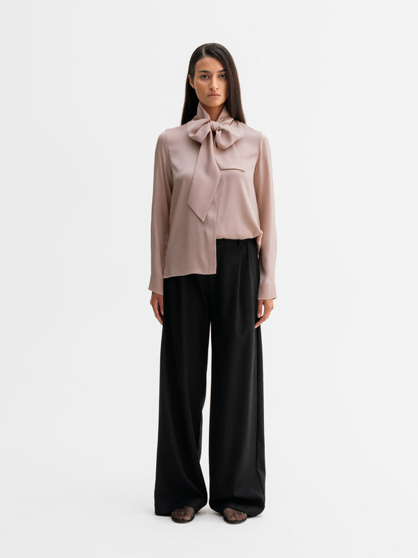 Model wearing Ahlvar Gallery Miki silk blouse in Dusty pink