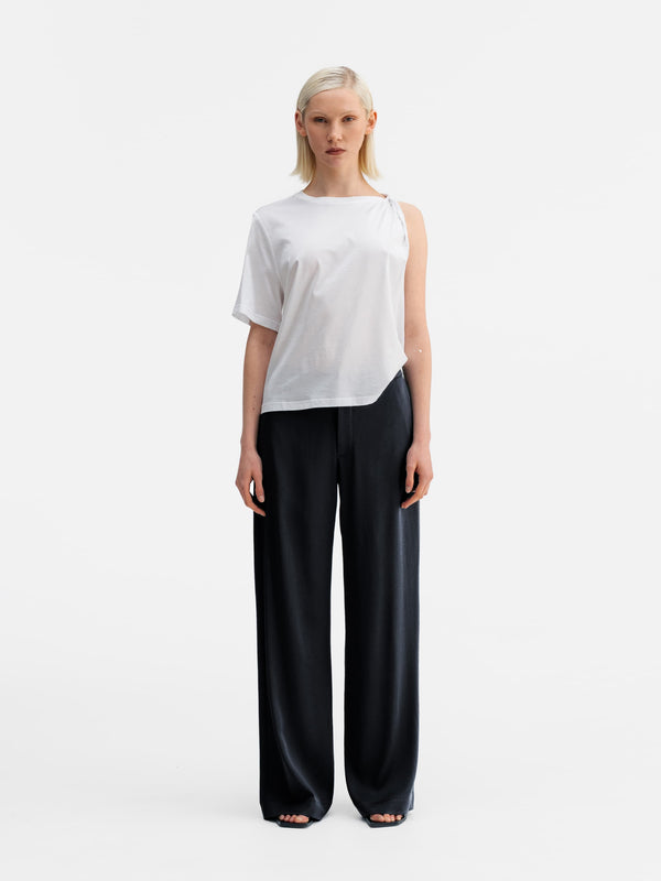 Model wearing Ahlvar Gallery Mila heavy satin trousers blue grey