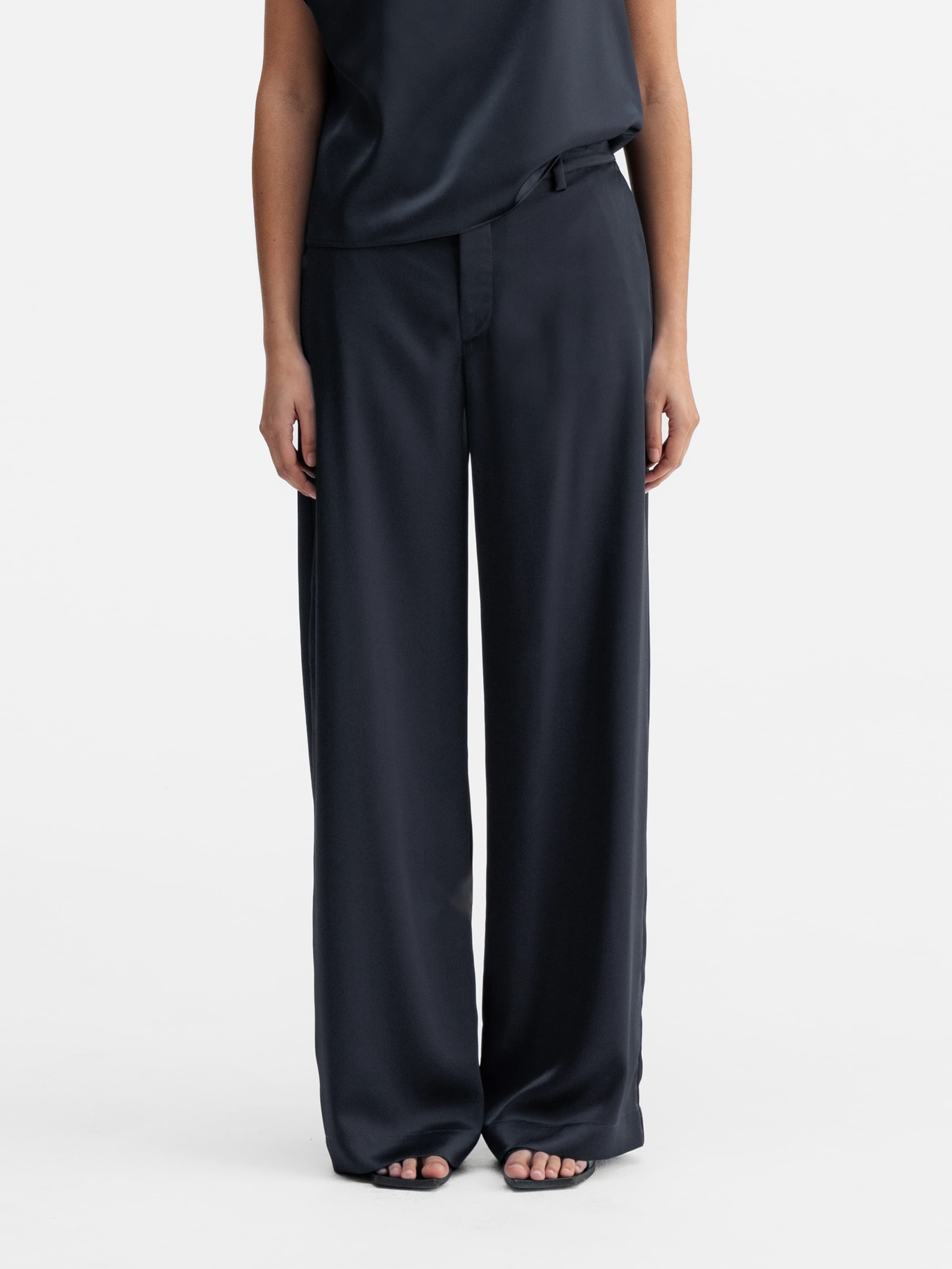 Model wearing Ahlvar Gallery Mila satin trousers blue grey