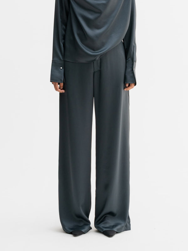 Model wearing Ahlvar Gallery Mila satin trousers in Dark grey