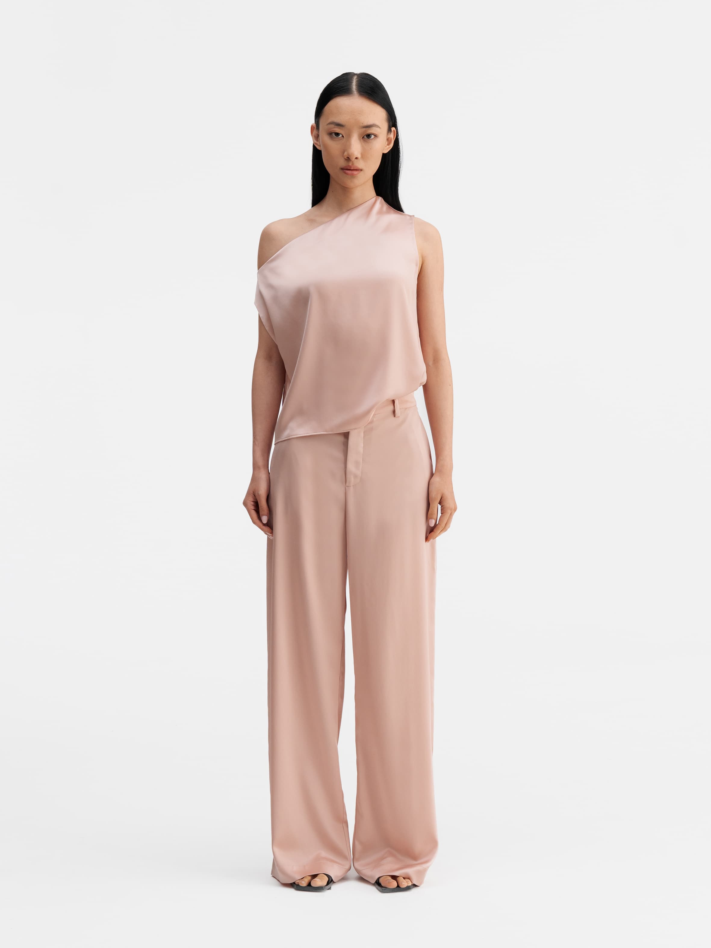Model wearing Ahlvar Gallery Mila satin trousers dusty pink