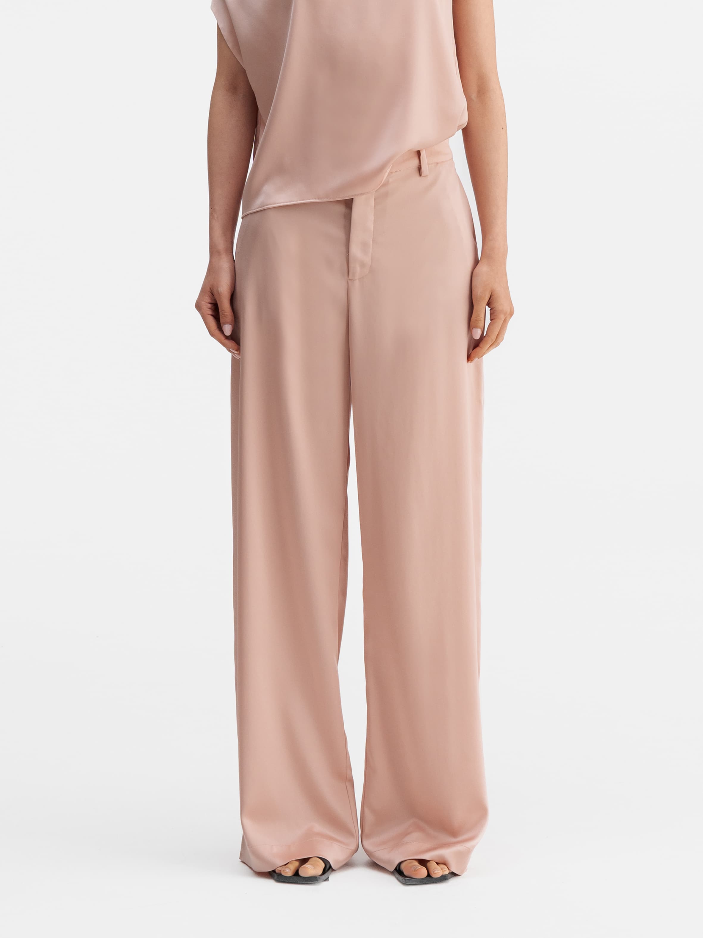 Model wearing Ahlvar Gallery Mila satin trousers dusty pink