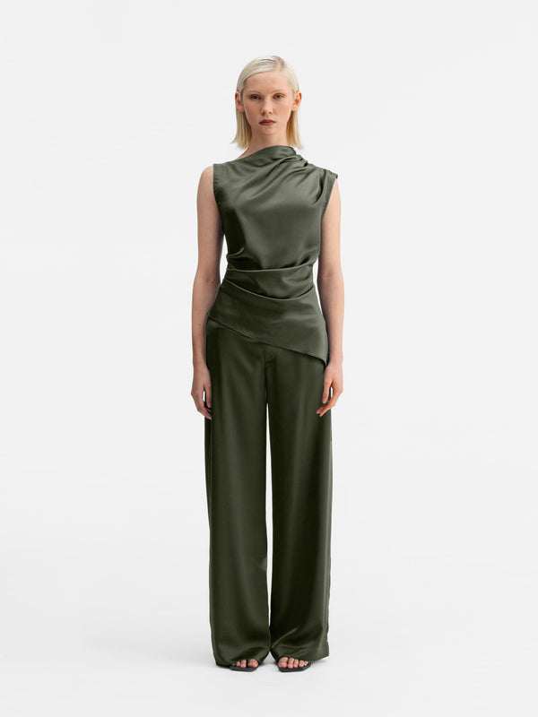 Model wearing Ahlvar Gallery Mila satin trousers olive green