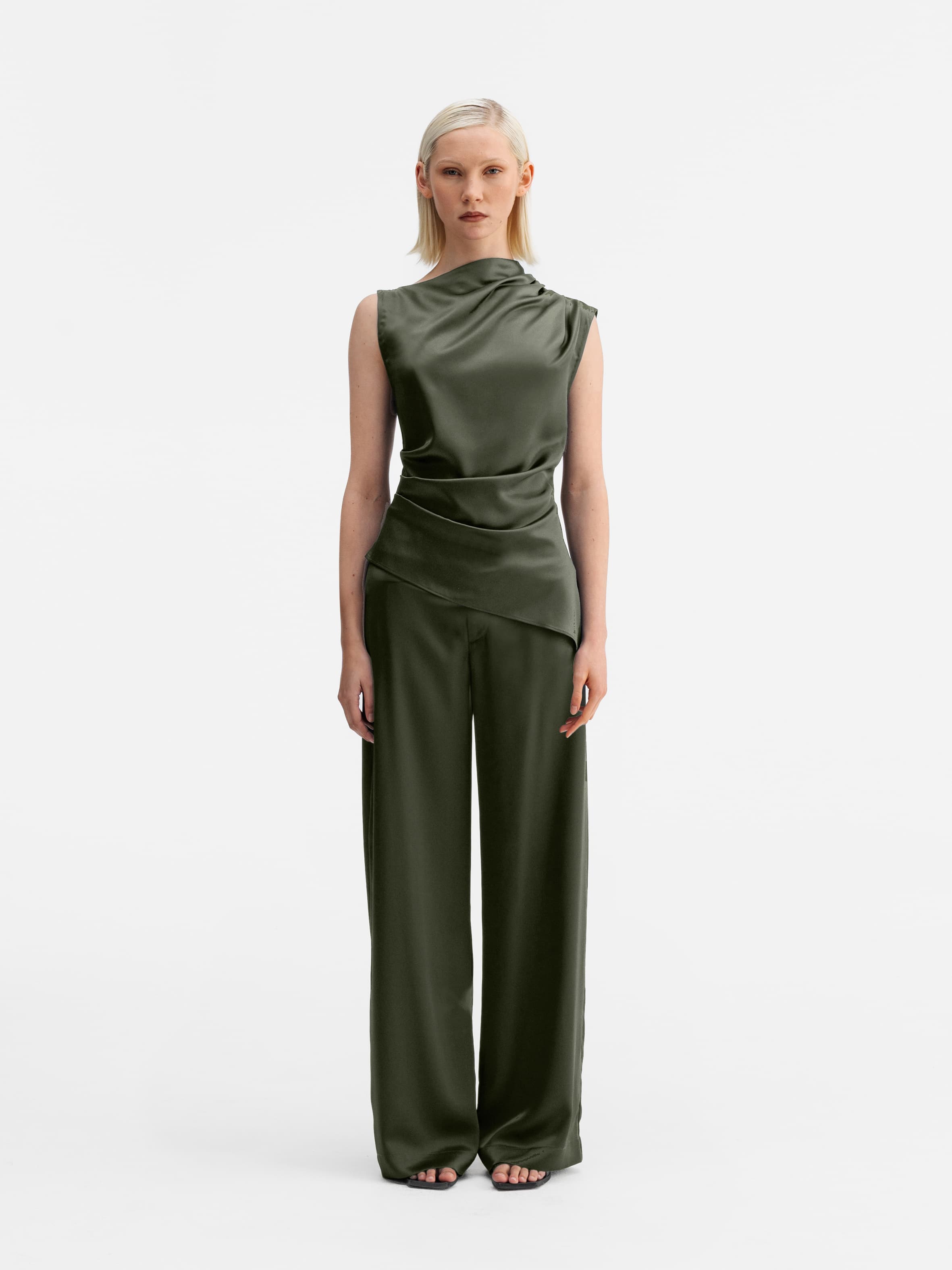 Model wearing Ahlvar Gallery Mila satin trousers olive green