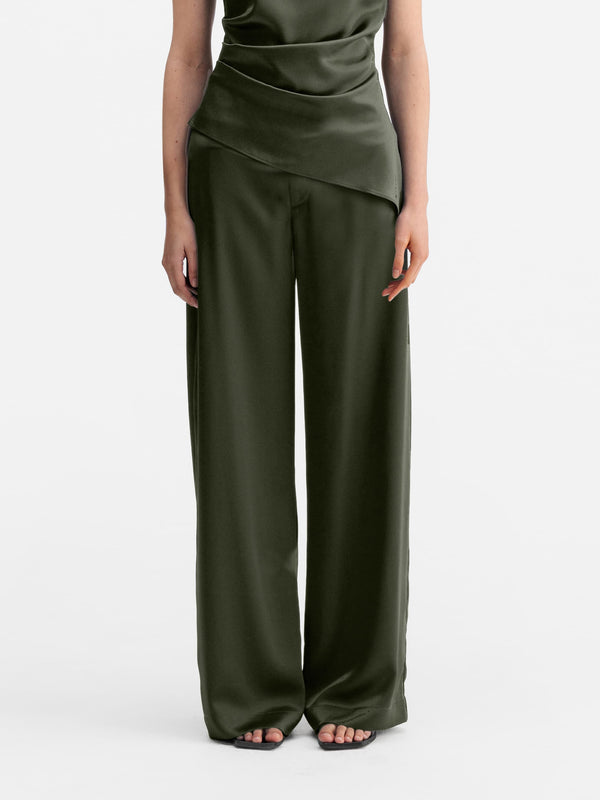 Model wearing Ahlvar Gallery Mila satin trousers olive green