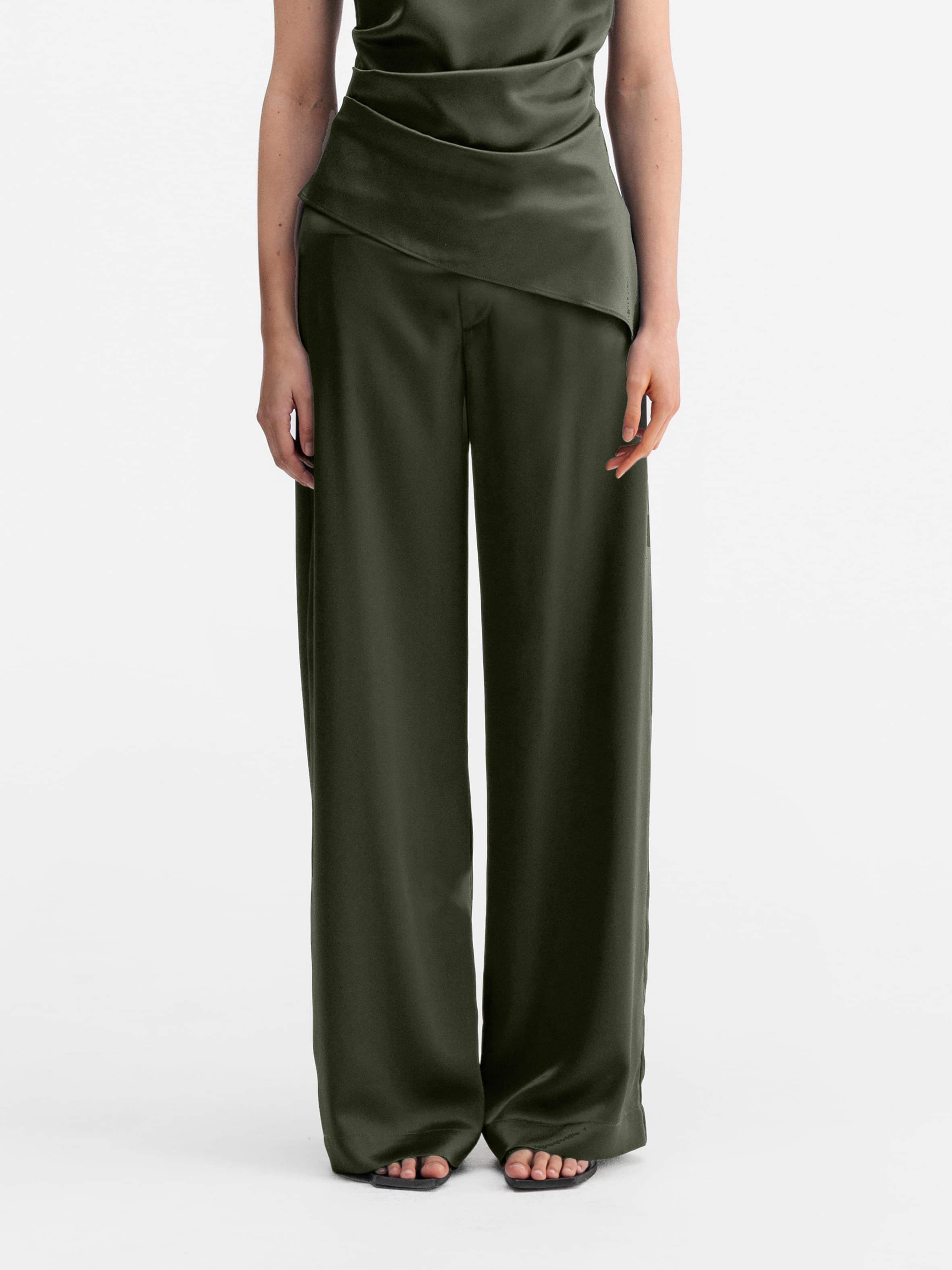 Model wearing Ahlvar Gallery Mila satin trousers olive green