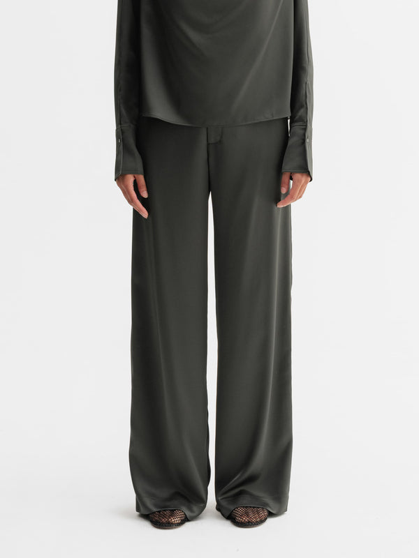 Model wearing Ahlvar Gallery Mila satin trousers in Wood