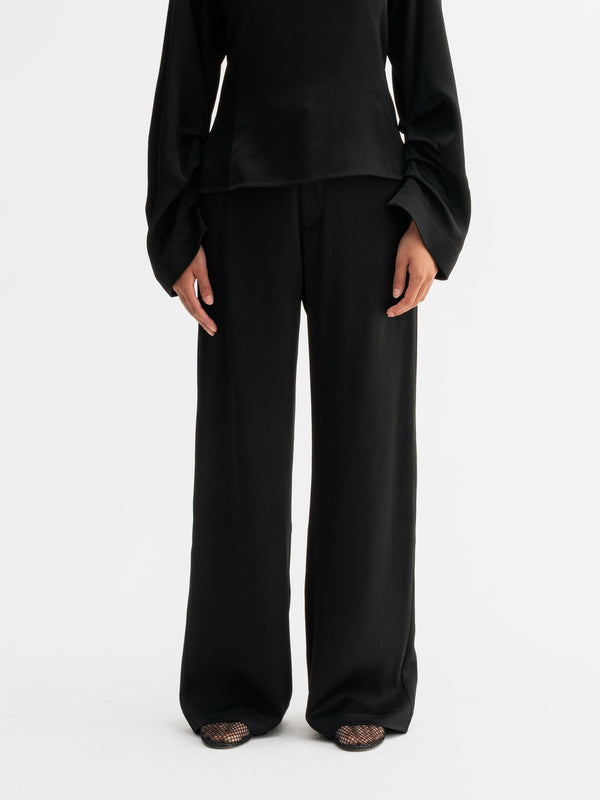 Model wearing Ahlvar Gallery Mila trousers in Black