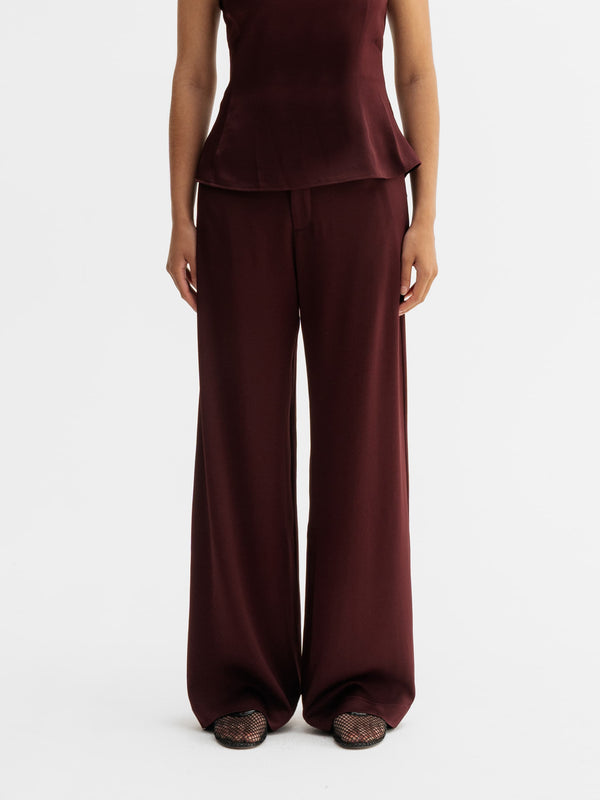 Model wearing Ahlvar Gallery Mila trousers in Burgundy