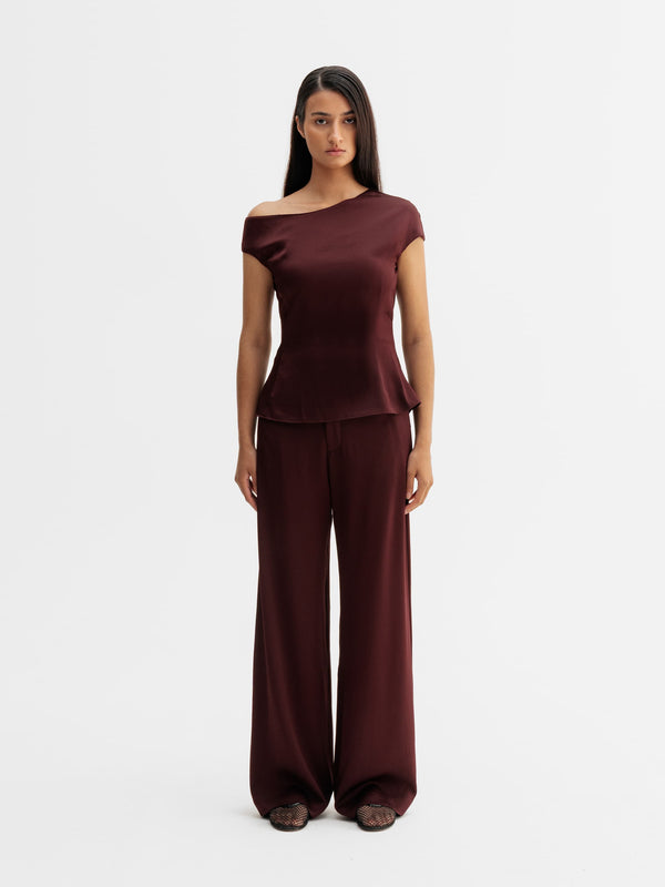 Model wearing Ahlvar Gallery Mila trousers in Burgundy
