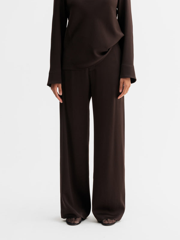 Model wearing Ahlvar Gallery Mila trousers in Dark brown