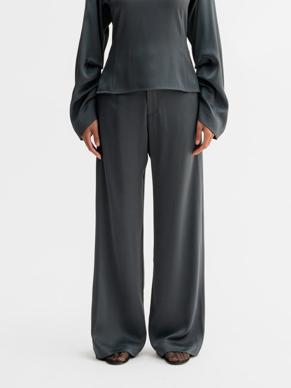 Model wearing Ahlvar Gallery Mila trousers in Dark grey