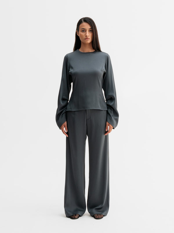 Model wearing Ahlvar Gallery Mila trousers in Dark grey