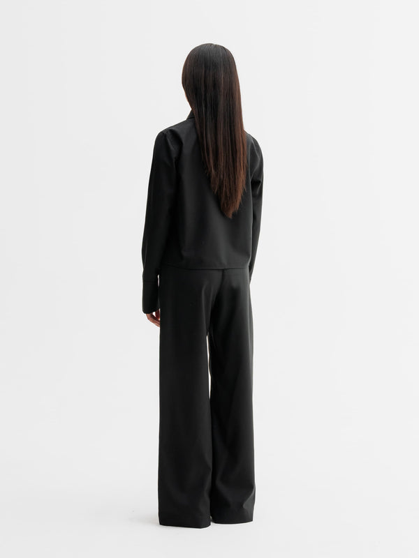 Back view of Ahlvar Gallery Mila wool trousers in Black