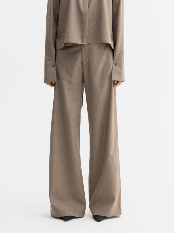 Model wearing Ahlvar Gallery Mila wool trousers in Light brown