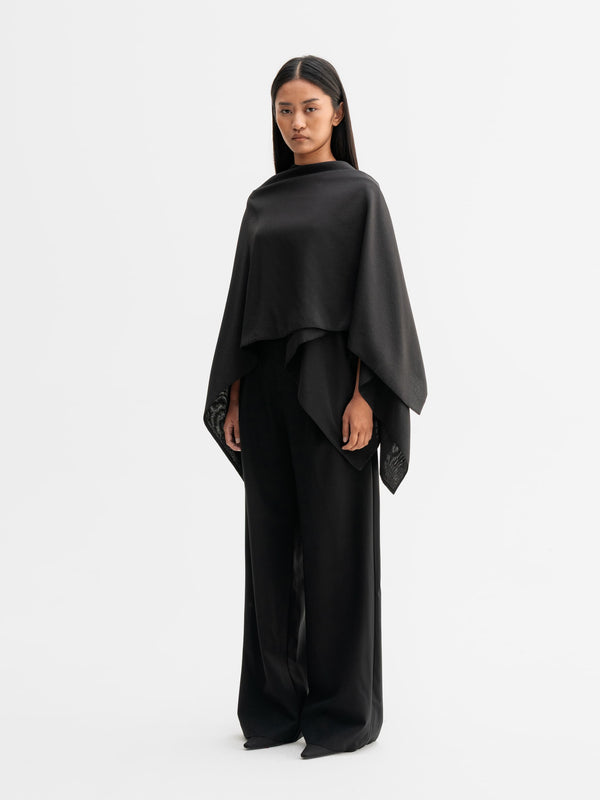 Model wearing Ahlvar Gallery Niki cape in Black