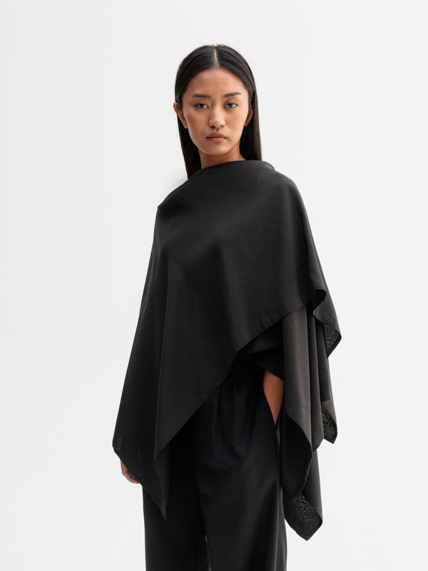 Model wearing Ahlvar Gallery Niki cape in Black