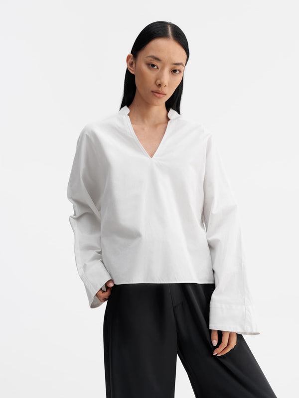 Model wearing Ahlvar Gallery Nina v-neck oxford blouse white