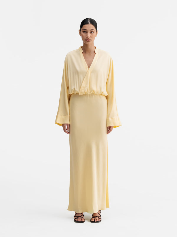 Model wearing Ahlvar Gallery Niva dress light yellow