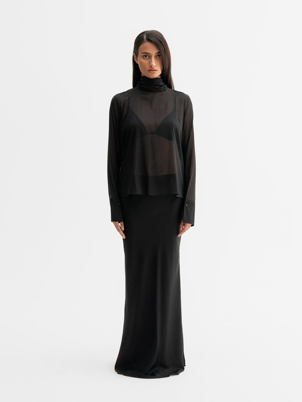Model wearing Ahlvar Gallery Rika see-through silk blouse in Black