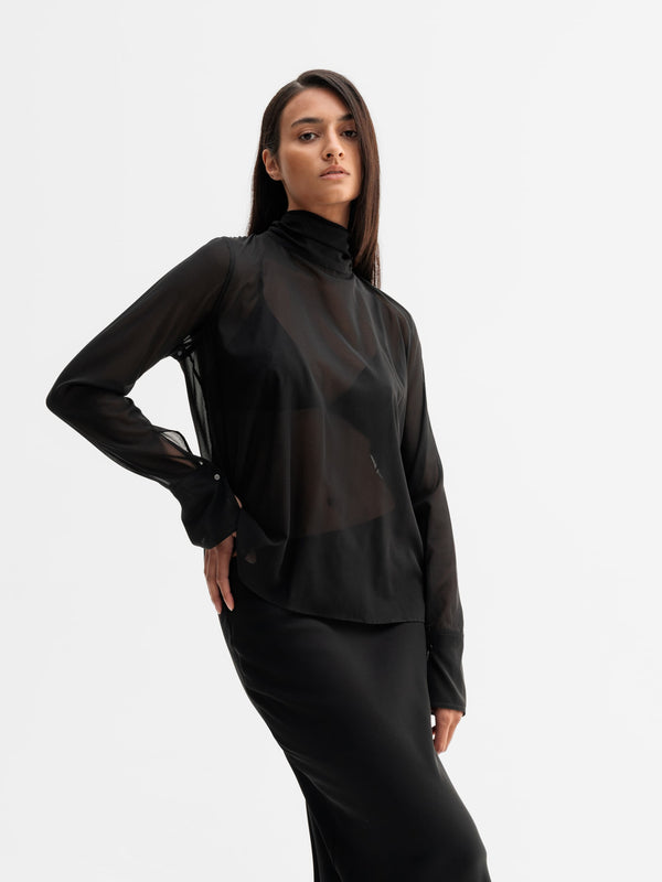Model wearing Ahlvar Gallery Rika see-through silk blouse in Black