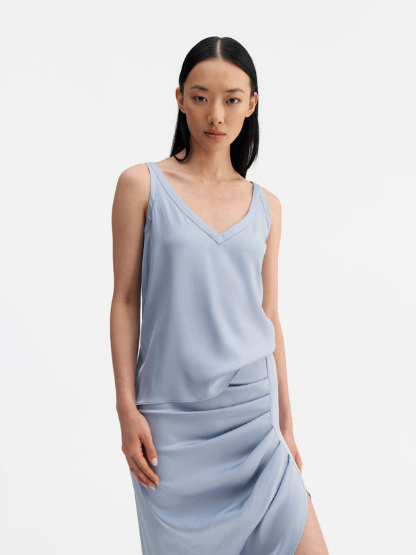 Model wearing Ahlvar Gallery Shin silk tank in denim blue