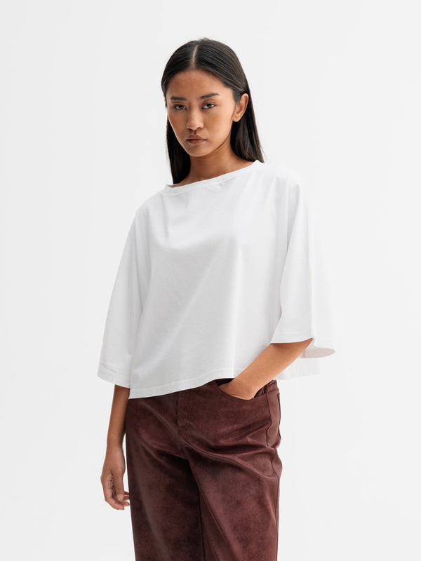 Model wearing Ahlvar Gallery Thea jersey tee in White