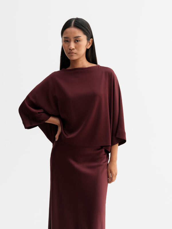 Model wearing Ahlvar Gallery Thea silk tee in Burgundy