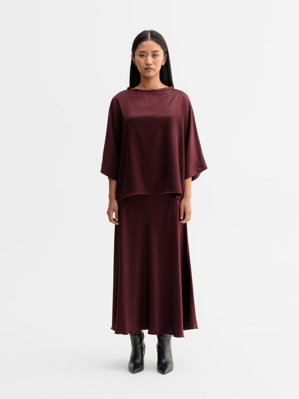 Model wearing Ahlvar Gallery Tori satin tee in Burgundy