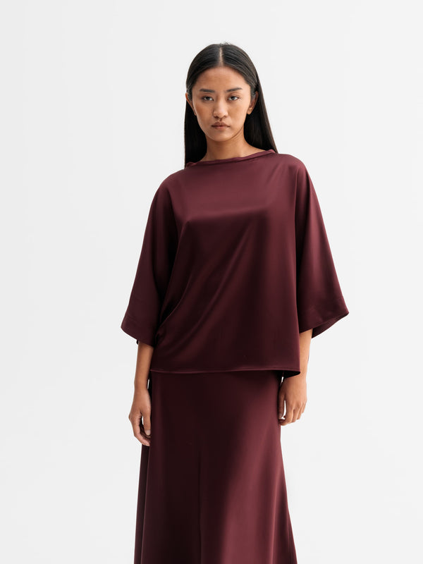 Model wearing Ahlvar Gallery Tori satin tee in Burgundy