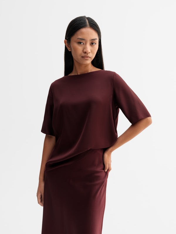 Model wearing Ahlvar Gallery Yoli silk blouse in Burgundy