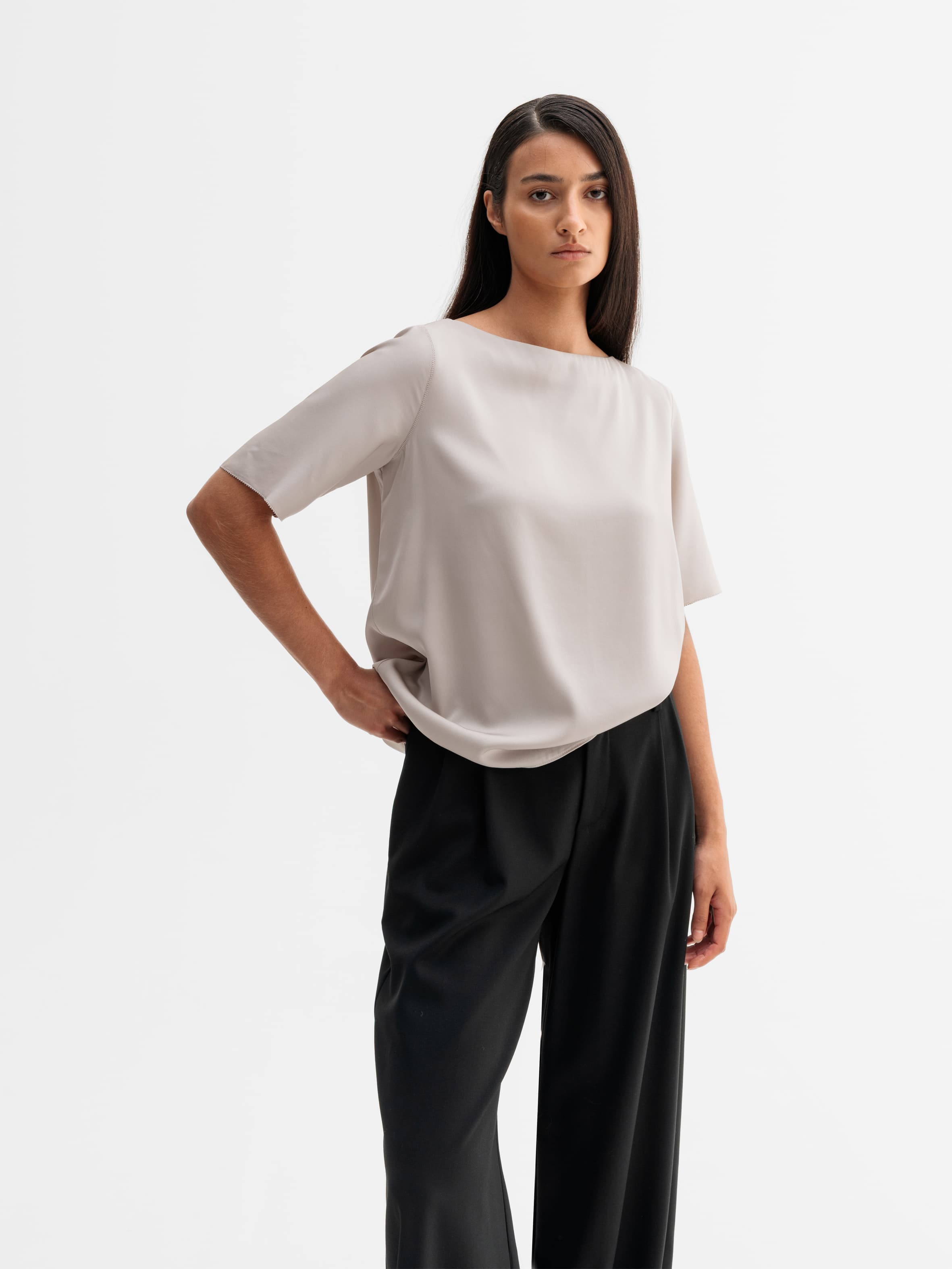 Model wearing Ahlvar Gallery Yoli silk blouse in Greige
