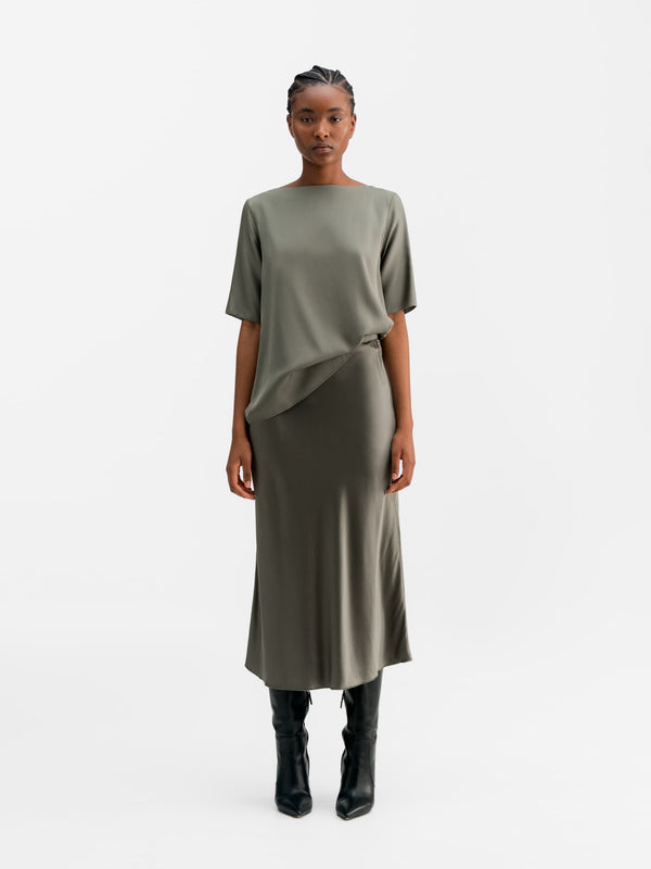 Model wearing Ahlvar Gallery Yoli silk blouse light military