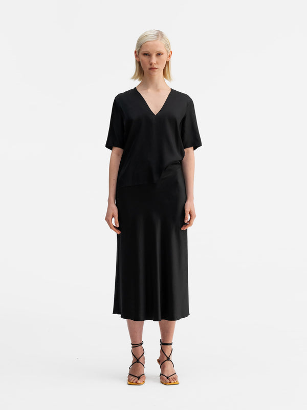 Model wearing Ahlvar Gallery Yoli v-neck silk blouse black